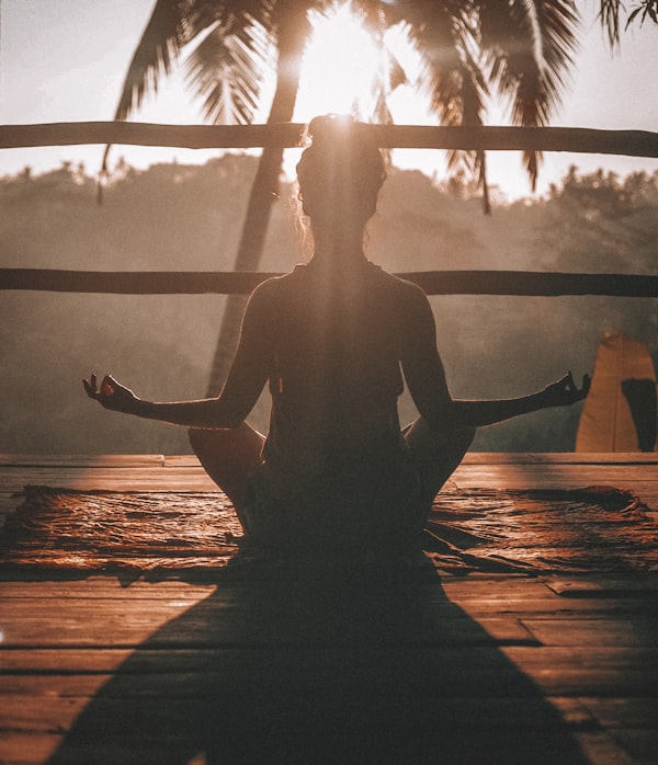 Person meditating peacefully outdoors in nature